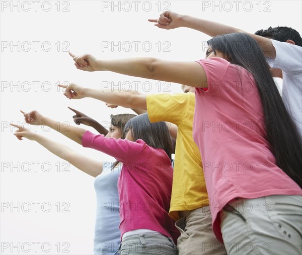 Group of friends pointing. Photographe : momentimages