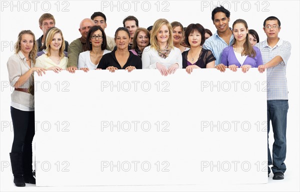 Group of people holding blank billboard. Photographe : momentimages