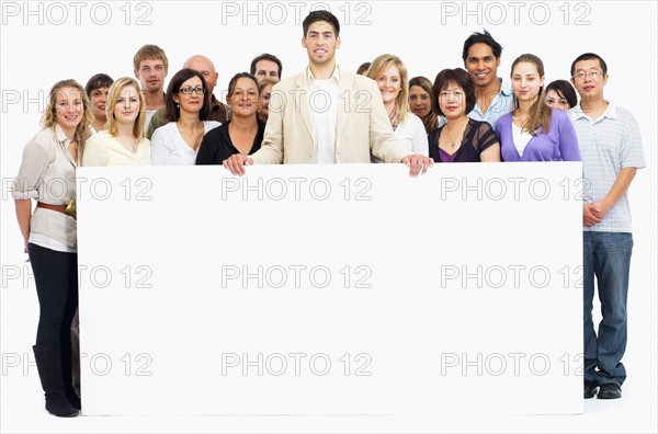 Group of people holding blank billboard. Photographe : momentimages