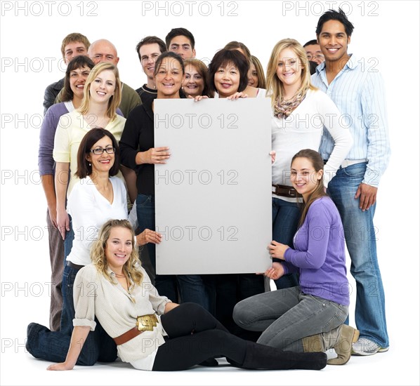 Group of people holding blank billboard. Photographe : momentimages