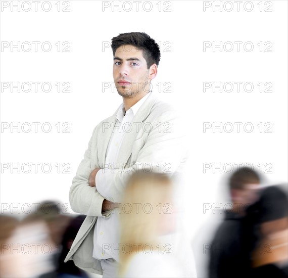 One person standing amongst a blur of other people. Photographe : momentimages