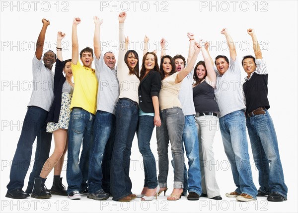 Group of people raising their arms. Photographe : momentimages