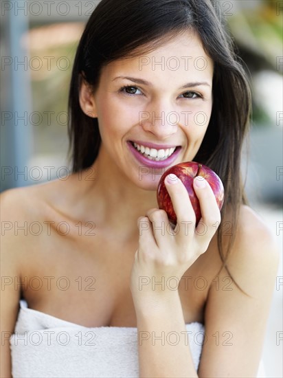 Woman eating an apple. Photographe : momentimages