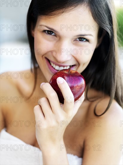 Woman eating an apple. Photographe : momentimages