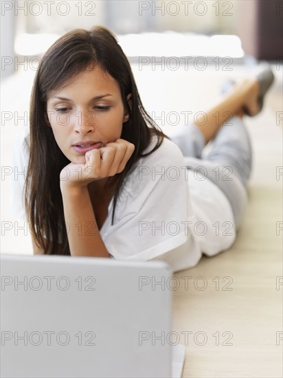 Woman looking at laptop. Photographe : momentimages