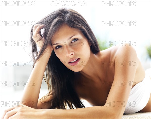 Woman relaxing by pool. Photographe : momentimages