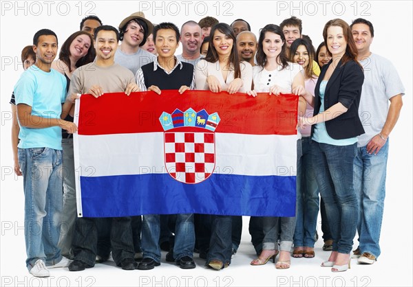 Group of people holding flag. Photographe : momentimages