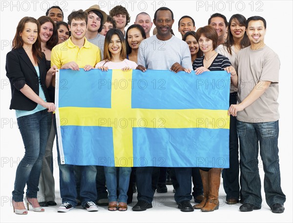 Group of people holding flag. Photographe : momentimages