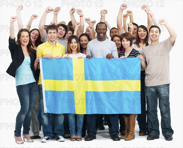 Group of people holding flag. Photographe : momentimages