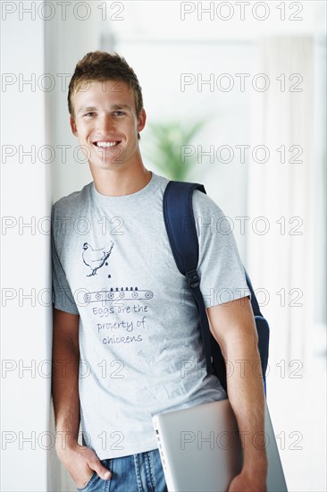 Student holding laptop. Photographe : momentimages