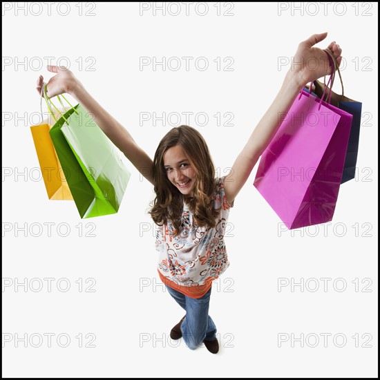 Young girl holding shopping bags. Photographe : Mike Kemp