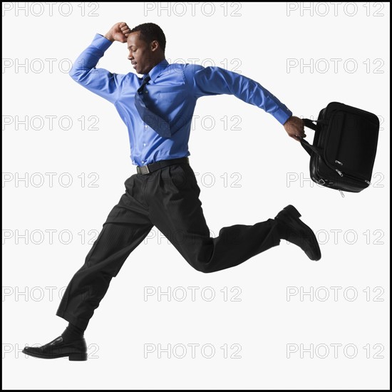 Businessman running. Photographe : Mike Kemp