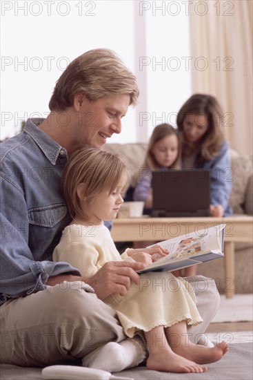 Family reading together. Photographe : Rob Lewine