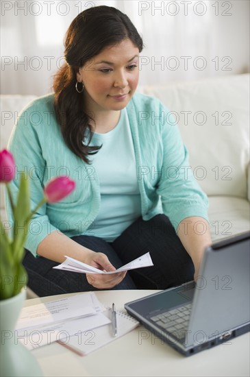 Woman paying bills online.