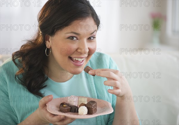 Woman eating chocolates.