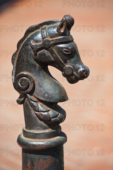 Iron statue of a horse's head.