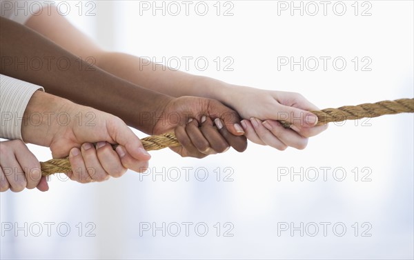 Hands pulling rope.