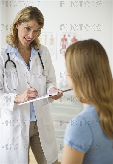 Doctor talking to patient in exam room.