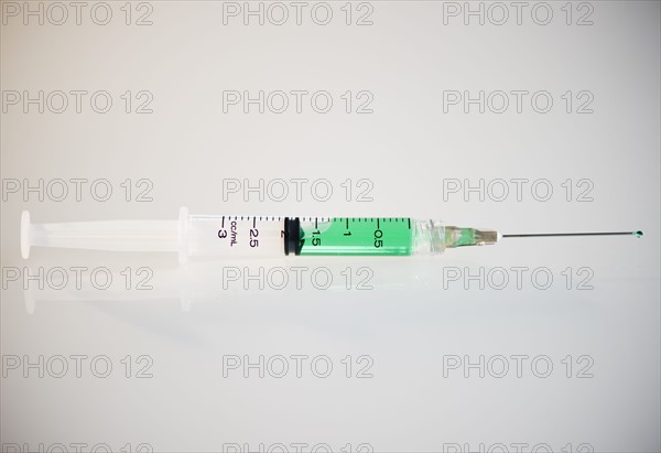 Syringe filled with green liquid. Photo : Jamie Grill