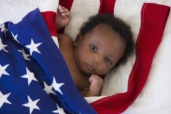 Baby wrapped in American flag. Photo : Daniel Grill