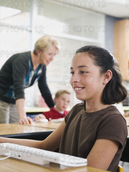 Students working on computers in classroom.