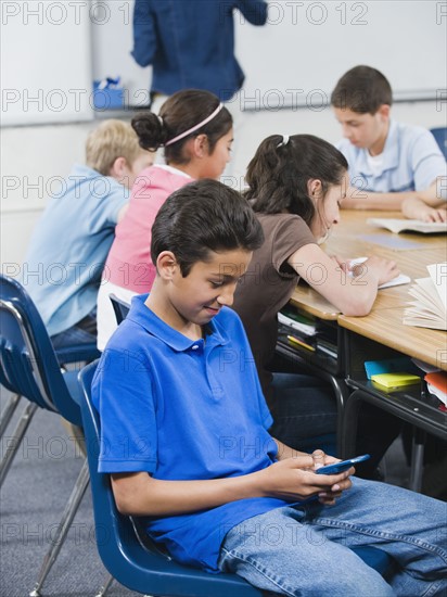 Student texting in classroom.