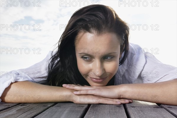 Brunette relaxing on porch. Photo : momentimages