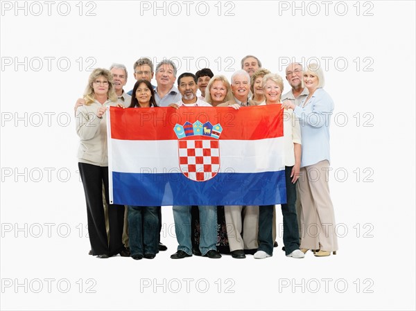 Group of people holding a Croatian flag. Photo : momentimages