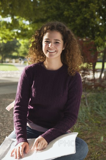 Teenage girl studying in the park. Photo : Stewart Cohen