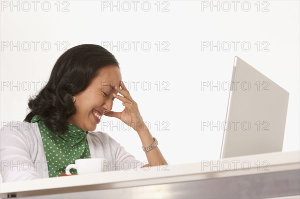 Happy woman looking at laptop. Photo : K.Hatt