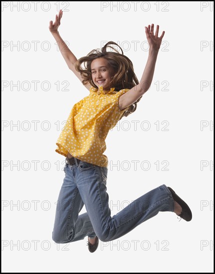 Excited teenage girl jumping for joy. Photo : Mike Kemp