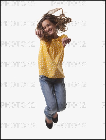 Excited teenage girl jumping for joy. Photo : Mike Kemp