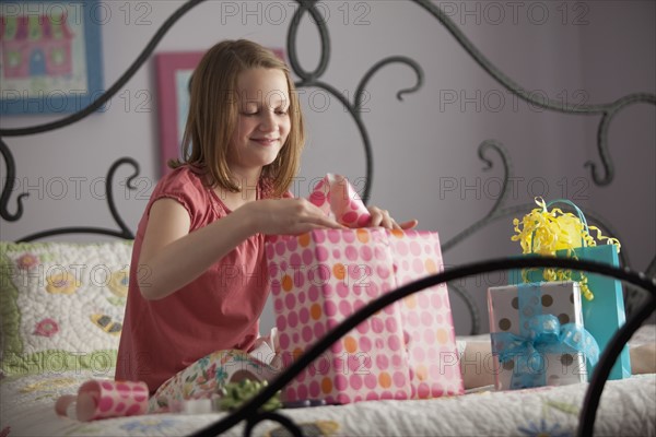 Young girl wrapping presents. Photo : Mike Kemp