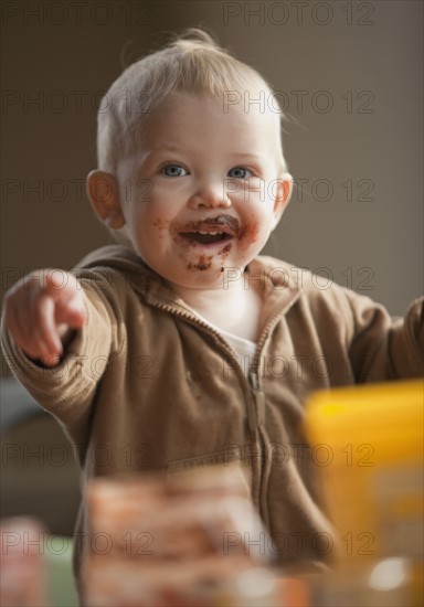 Baby with messy face. Photo : Mike Kemp