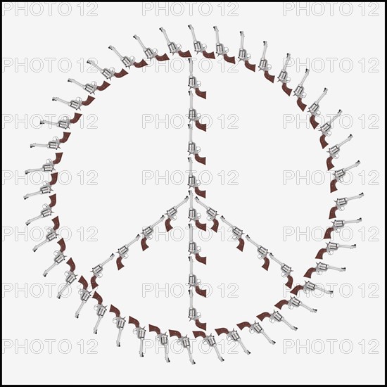 Guns arranged in the shape of a peace symbol. Photo : Mike Kemp