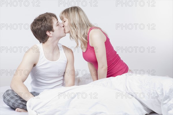 Couple kissing on bed. Photo : Take A Pix Media
