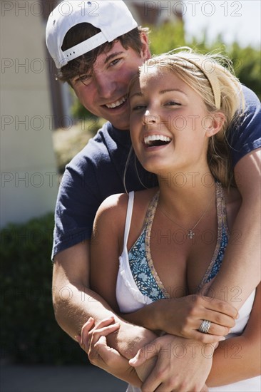 Teenage couple embracing. Photo : Stewart Cohen