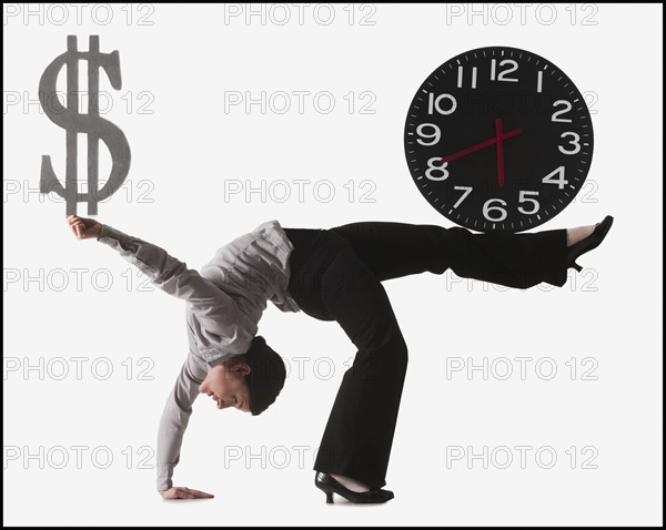 Businesswoman bending over backwards. Photo : Mike Kemp