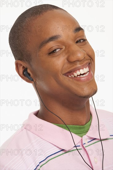 Smiling man wearing earphones. Photo : K.Hatt