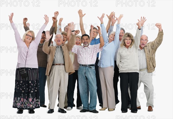 A group of excited people raising their arms in the air. Photo : momentimages