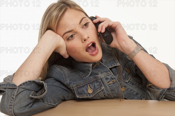 Bored woman having a telephone conversation. Photo : K.Hatt