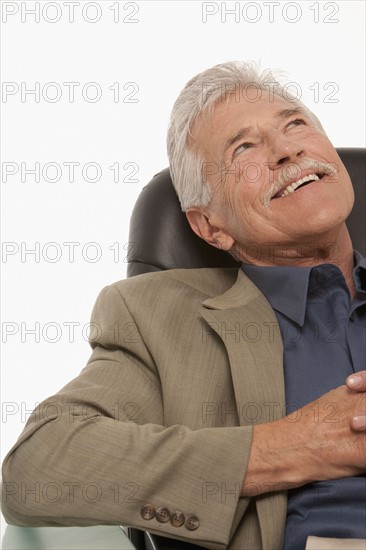 Businessman relaxing at his desk. Photo : K.Hatt