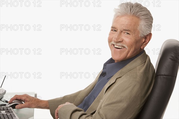 Businessman relaxing at his desk. Photo : K.Hatt