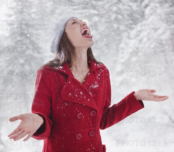 Woman trying to catch snow on her tongue. Photo : Mike Kemp