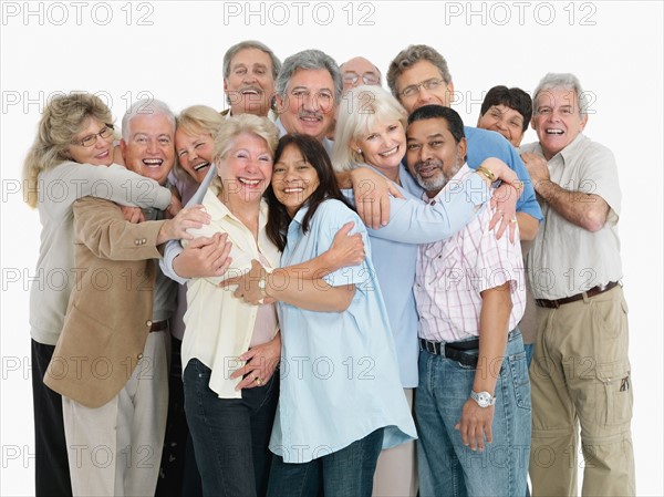 A group of people embracing. Photo : momentimages