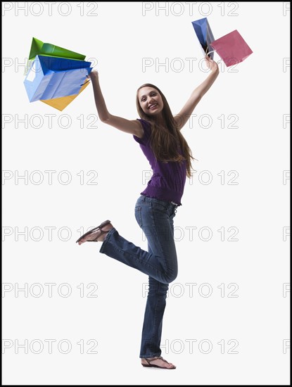 Teenage girl holding shopping bags. Photo : Mike Kemp