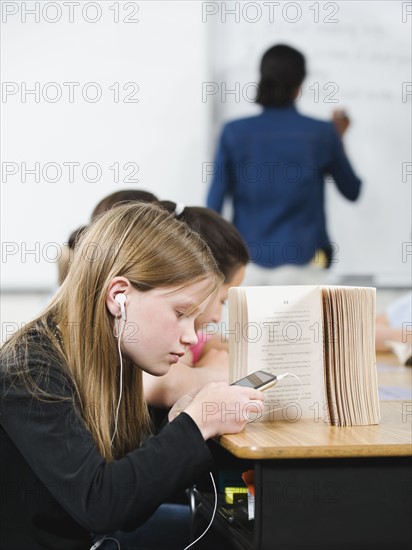 Student texting in classroom.