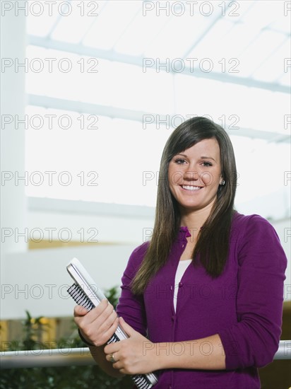 College student holding books.