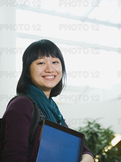 College student holding books.