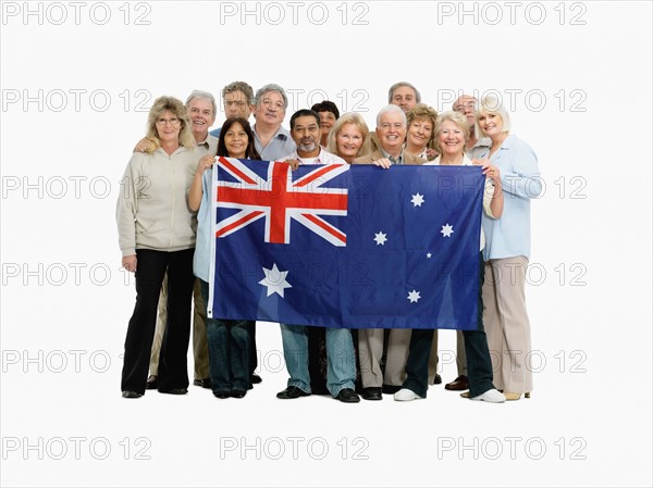 Group of people holding an Australian flag. Photo : momentimages